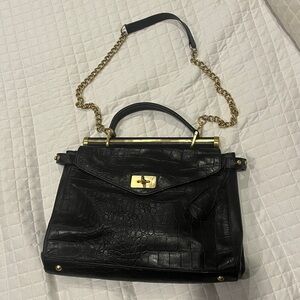 Elegant Black leather Handbag with Gold Chain by BCBGMAXAZRIA.